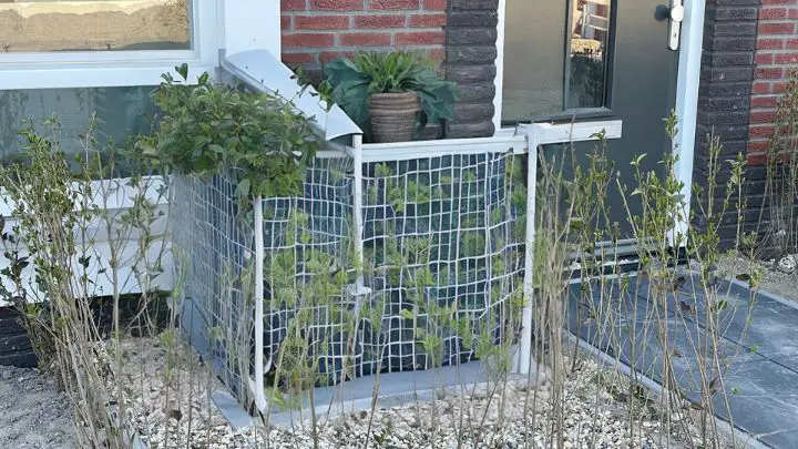 build a metal fence like cover for heat pump