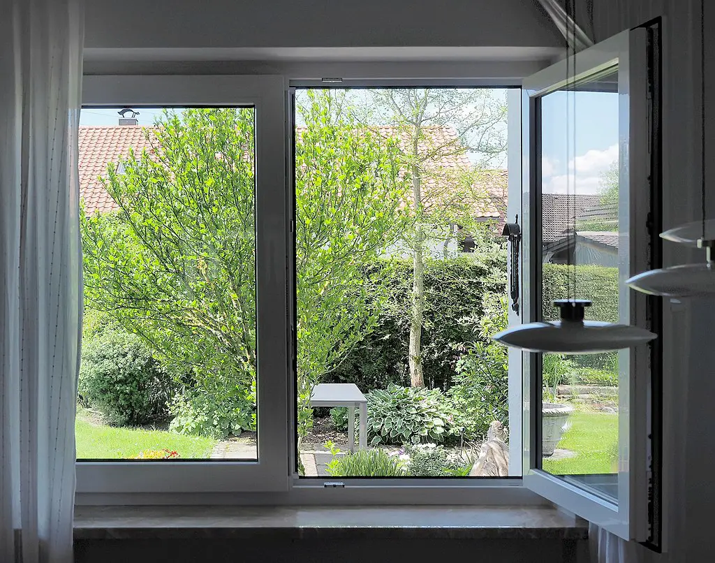 1024px View into a garden through an open ground floor window in Germany